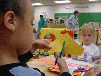 A child is cutting out paper with scissors.
