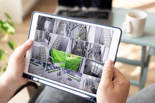 A person holding an ipad with pictures of stairs on it.